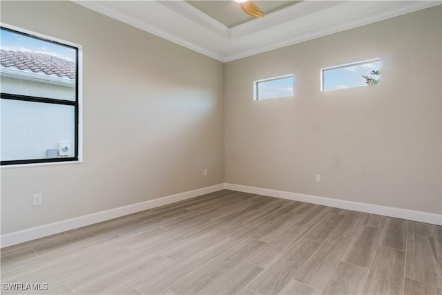 4320 Vasco St, Punta Gorda, FL 33950 - empty room featuring light wood-style flooring, baseboards, a raised ceiling, and ornamental molding
