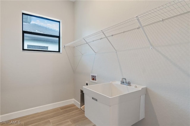 4320 Vasco St, Punta Gorda, FL 33950 - washroom with laundry area, baseboards, hookup for an electric dryer, light wood-type flooring, and washer hookup