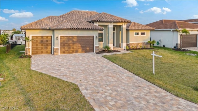 4320 Vasco St, Punta Gorda, FL 33950 - mediterranean / spanish house featuring decorative driveway, stucco siding, an attached garage, a front yard, and stone siding