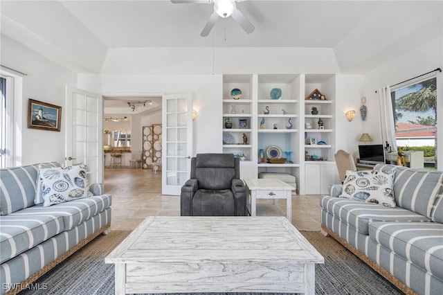 living area with a ceiling fan, french doors, and light tile patterned flooring