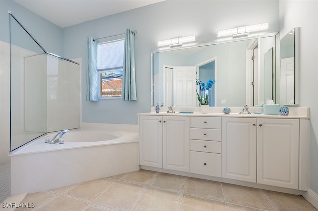 full bathroom with tile patterned flooring, double vanity, a sink, and a bath