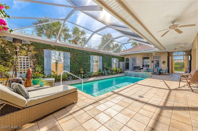 outdoor pool with a lanai, a patio area, ceiling fan, and area for grilling