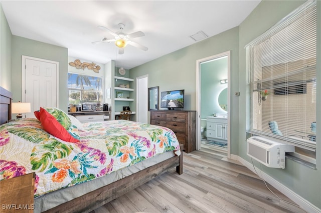 bedroom featuring baseboards, visible vents, connected bathroom, ceiling fan, and light wood-type flooring