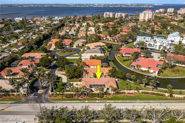 drone / aerial view with a water view and a residential view