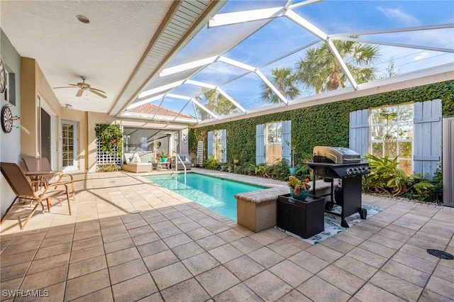 outdoor pool with a patio, glass enclosure, grilling area, and a ceiling fan