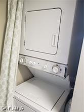 laundry area with stacked washer / drying machine