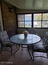 dining area with brick wall