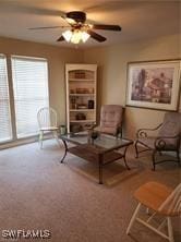 living room with ceiling fan and carpet flooring