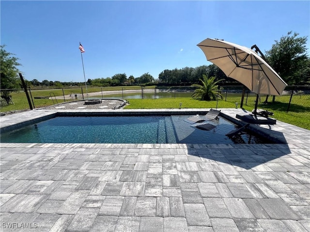 view of pool featuring a fire pit, a water view, a patio area, and a lawn