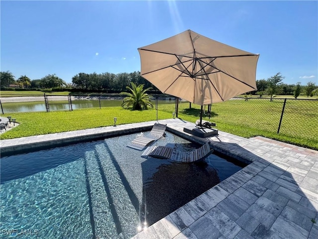 view of swimming pool with a patio, a water view, and a lawn