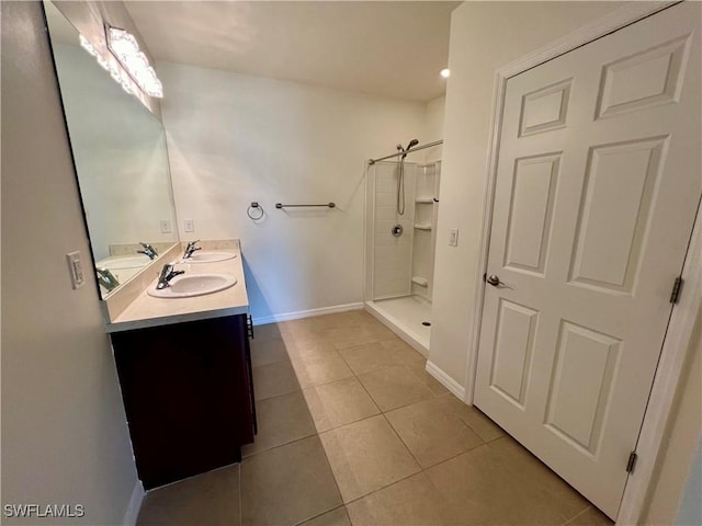 bathroom featuring tile patterned flooring, vanity, and a shower