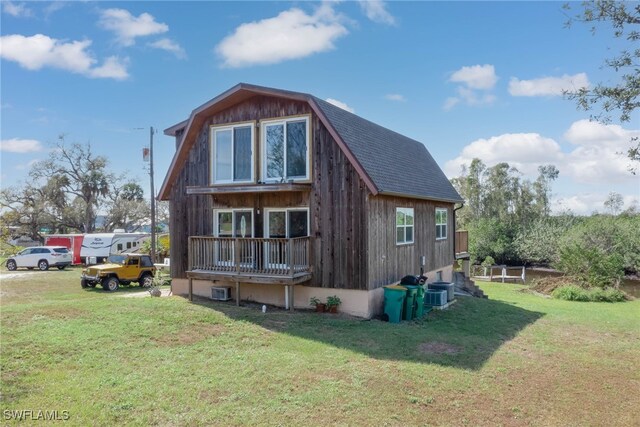 373 Hile Ln, Punta Gorda, FL 33982 - back of property featuring a yard, roof with shingles, and a gambrel roof