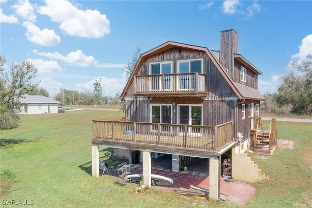 373 Hile Ln, Punta Gorda, FL 33982 - back of house with a balcony, a yard, a deck, and a gambrel roof
