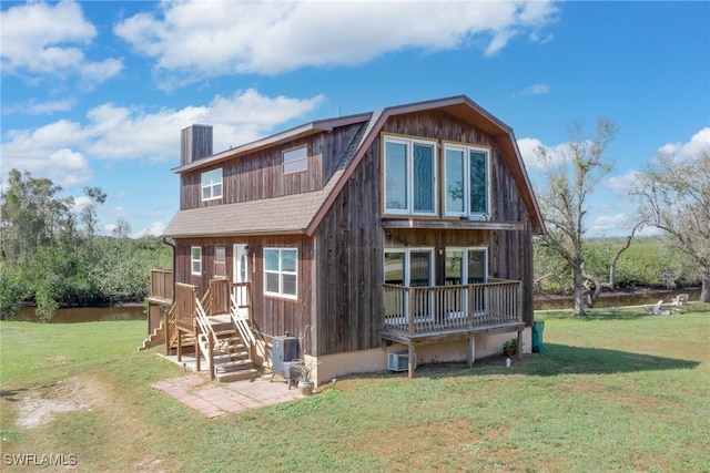 373 Hile Ln, Punta Gorda, FL 33982 - back of house featuring a chimney, a lawn, a gambrel roof, and a wooden deck