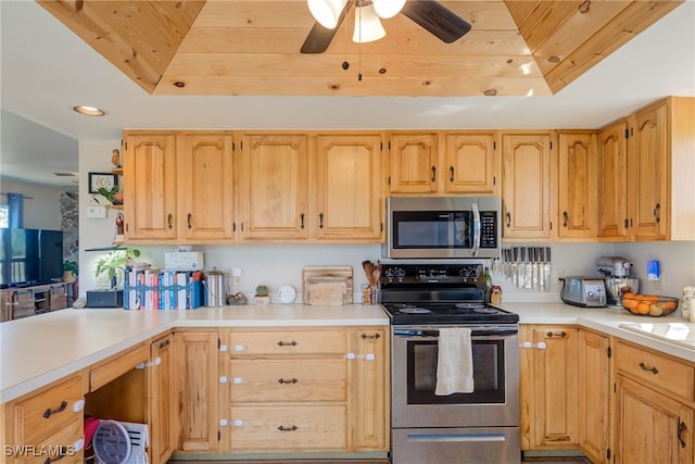 373 Hile Ln, Punta Gorda, FL 33982 - kitchen featuring appliances with stainless steel finishes, a tray ceiling, wooden ceiling, light countertops, and a ceiling fan