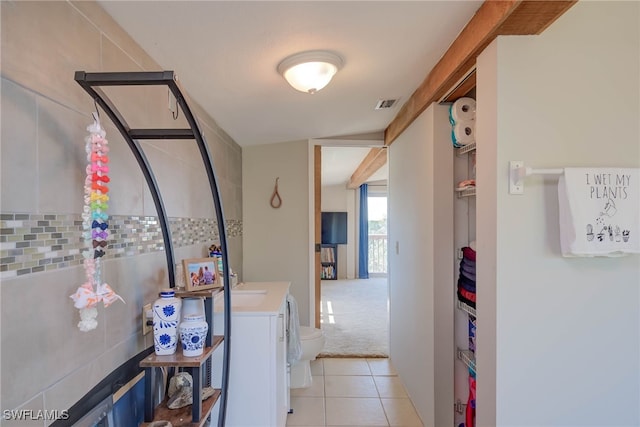 373 Hile Ln, Punta Gorda, FL 33982 - corridor featuring light tile patterned floors, light colored carpet, and independent washer and dryer