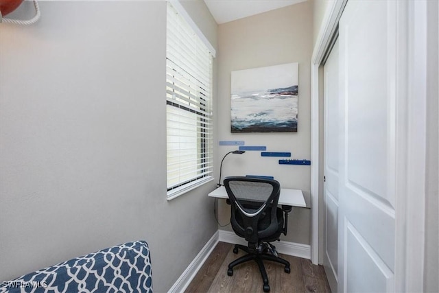 office space featuring baseboards and wood finished floors