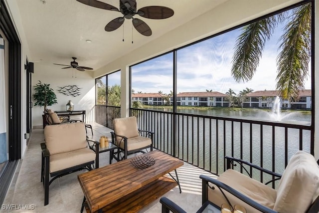 sunroom / solarium with a residential view and a water view