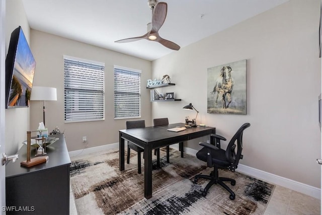 tiled office featuring baseboards and a ceiling fan