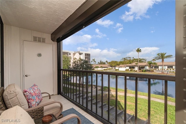 balcony featuring a water view