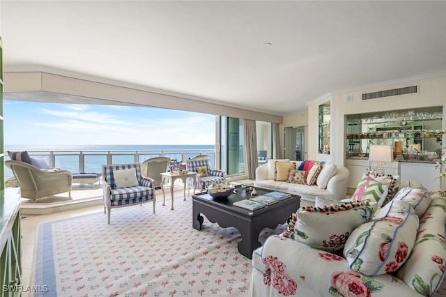 living room with a water view and ornamental molding