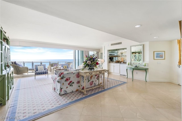 living room with a water view and light tile patterned floors