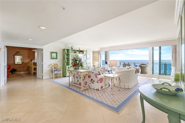 living room with wooden walls, a water view, and light tile patterned flooring