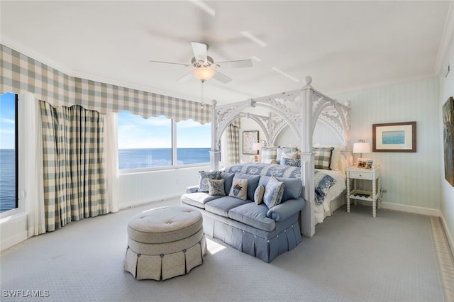 bedroom with a water view, carpet, crown molding, and ceiling fan