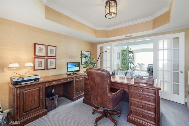 carpeted office featuring ornamental molding and a raised ceiling