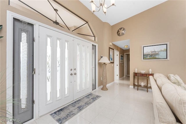 foyer with light tile patterned flooring and a chandelier