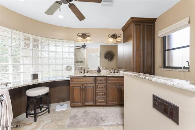 bathroom featuring vanity, ceiling fan, and walk in shower