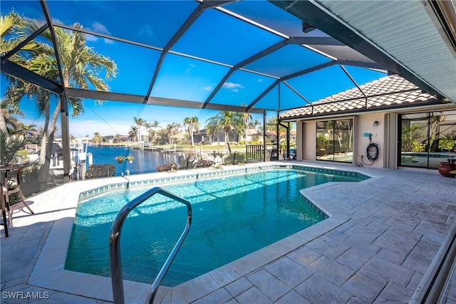 view of swimming pool featuring a water view, glass enclosure, and a patio area