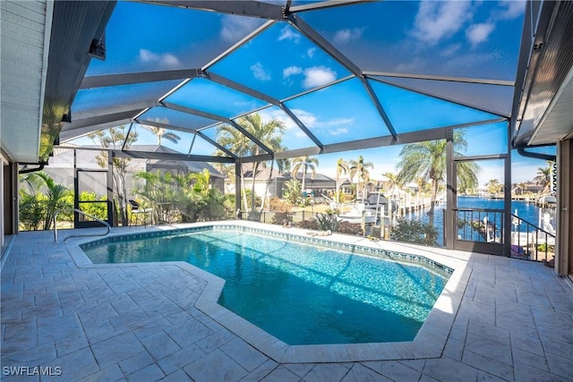 view of pool with a patio, a water view, a boat dock, and a lanai