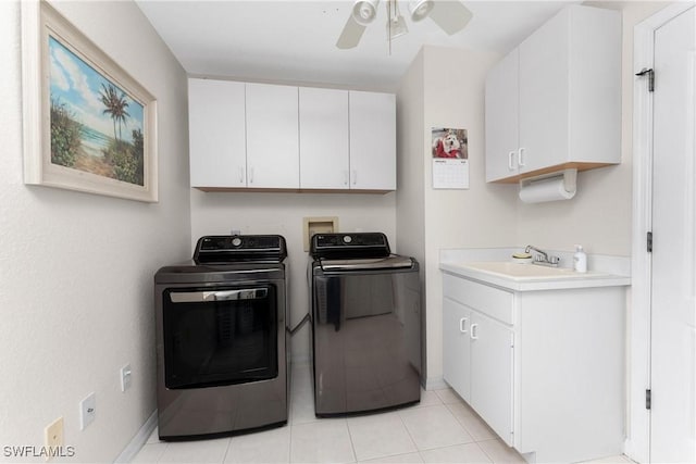 laundry area featuring light tile patterned flooring, sink, cabinets, ceiling fan, and washing machine and dryer