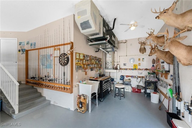 interior space featuring ceiling fan and a workshop area