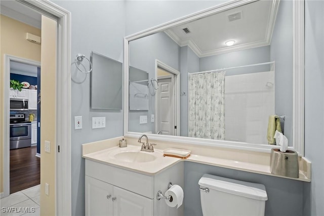 bathroom with ornamental molding, visible vents, vanity, and toilet
