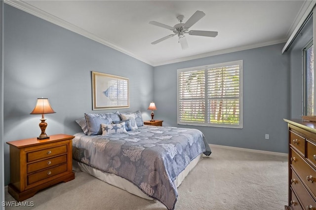 carpeted bedroom featuring baseboards, a ceiling fan, and crown molding