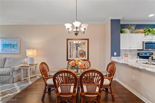 dining room with an inviting chandelier, baseboards, dark wood finished floors, and crown molding