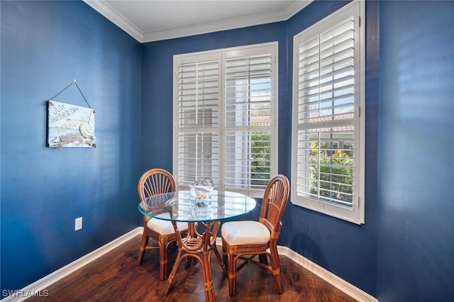dining area featuring crown molding, wood finished floors, and baseboards