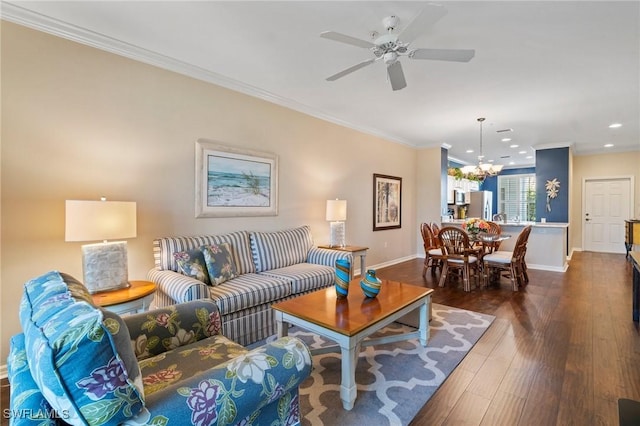 living area with recessed lighting, ceiling fan with notable chandelier, baseboards, dark wood finished floors, and crown molding