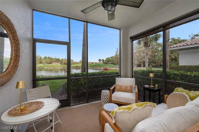 sunroom with a water view and ceiling fan