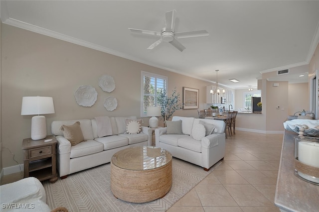 tiled living room featuring ornamental molding and ceiling fan with notable chandelier