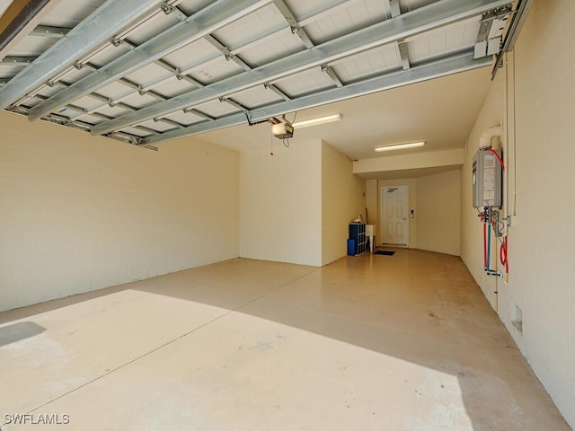 garage with water heater and a garage door opener