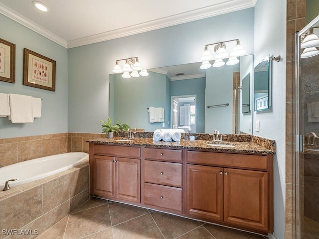 full bath with tile patterned flooring, a sink, ornamental molding, a bath, and a stall shower