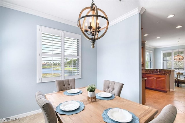 dining area with light tile patterned floors, crown molding, baseboards, and a notable chandelier