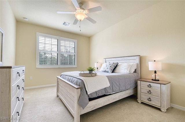 bedroom with baseboards, visible vents, ceiling fan, and light colored carpet