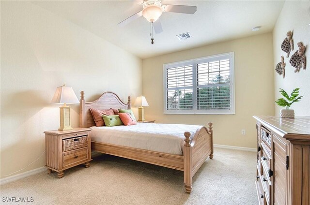 bedroom with light carpet, ceiling fan, visible vents, and baseboards