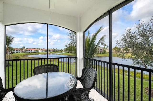 sunroom featuring a water view and plenty of natural light