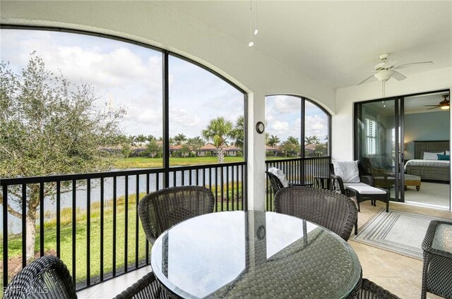 3159 Serena Ln Unit 201, Naples, FL 34114 - sunroom featuring a ceiling fan, a water view, outdoor dining space, and lofted ceiling