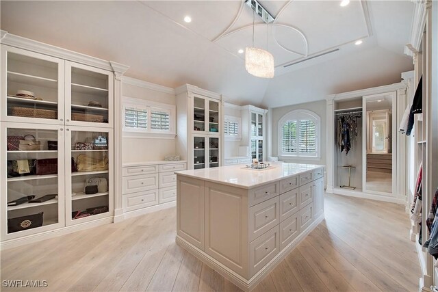233 Mermaids Bight, Naples, FL 34103 - spacious closet featuring light wood-type flooring and vaulted ceiling